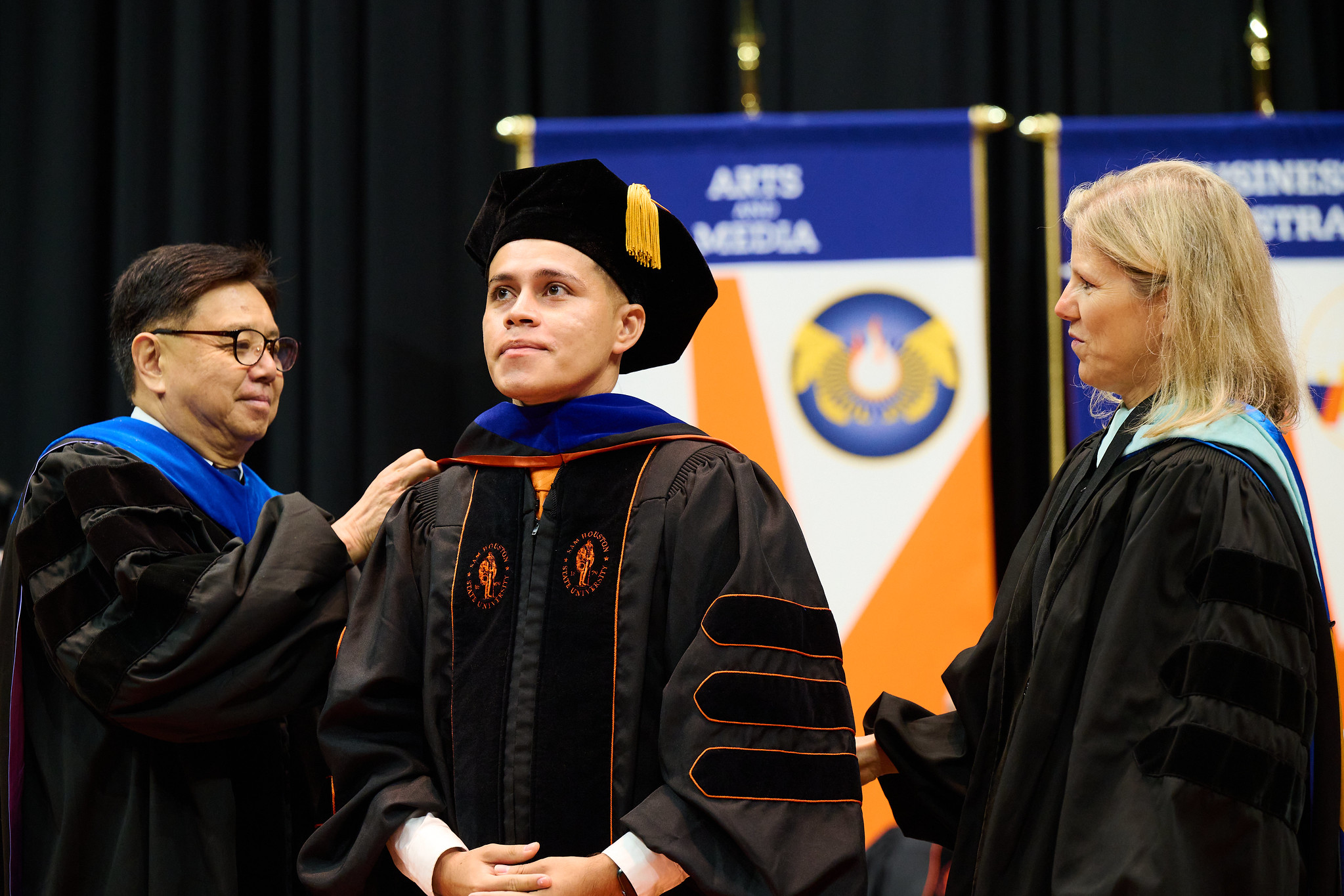 Student graduating standing proudly