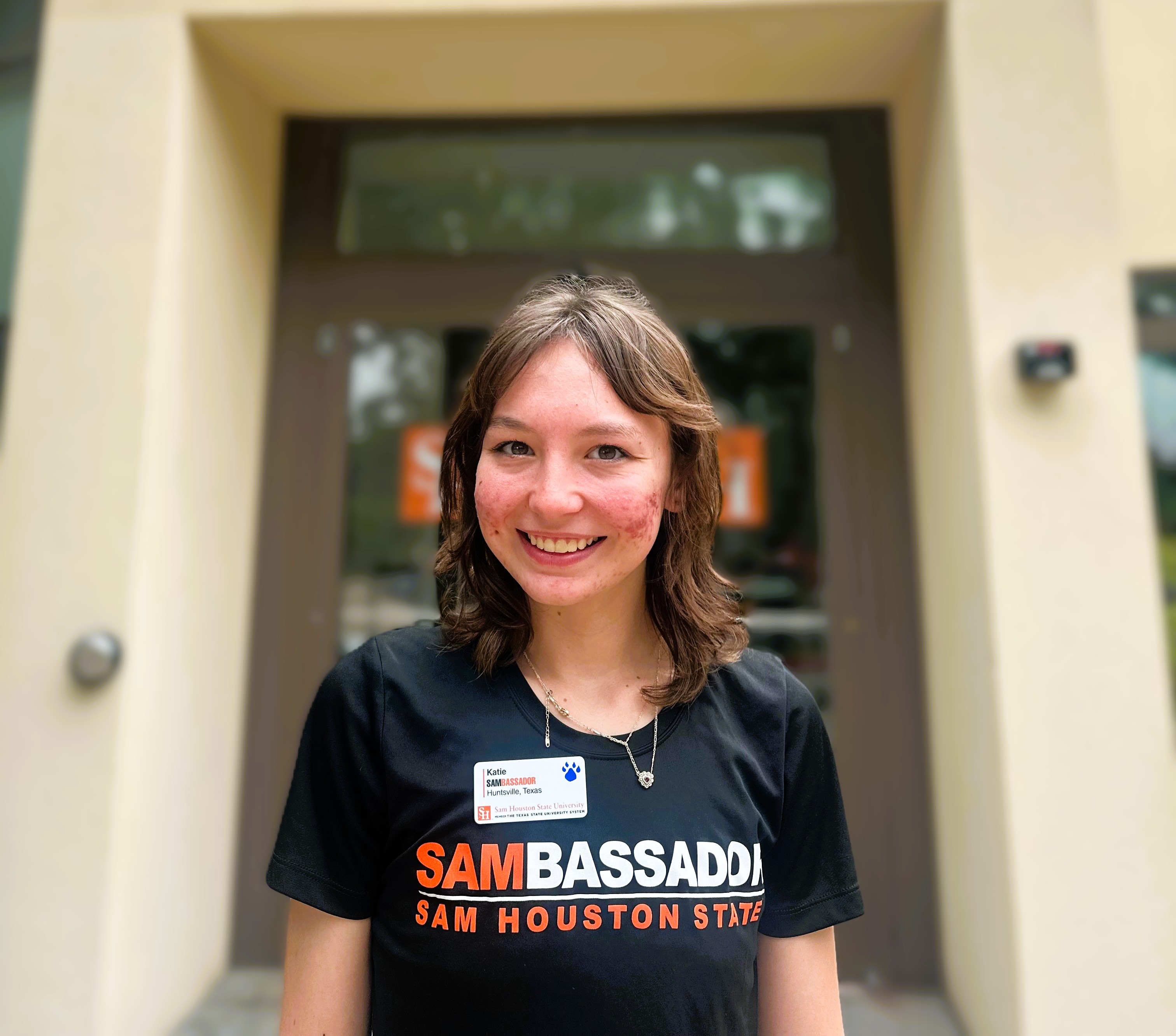 Photo of Katie Renee Culak in front of the Sam Houston State University Visitor Center. 