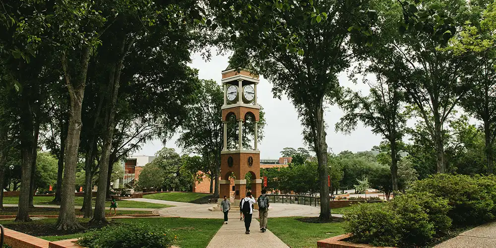 View of the clock tower with students walking. 